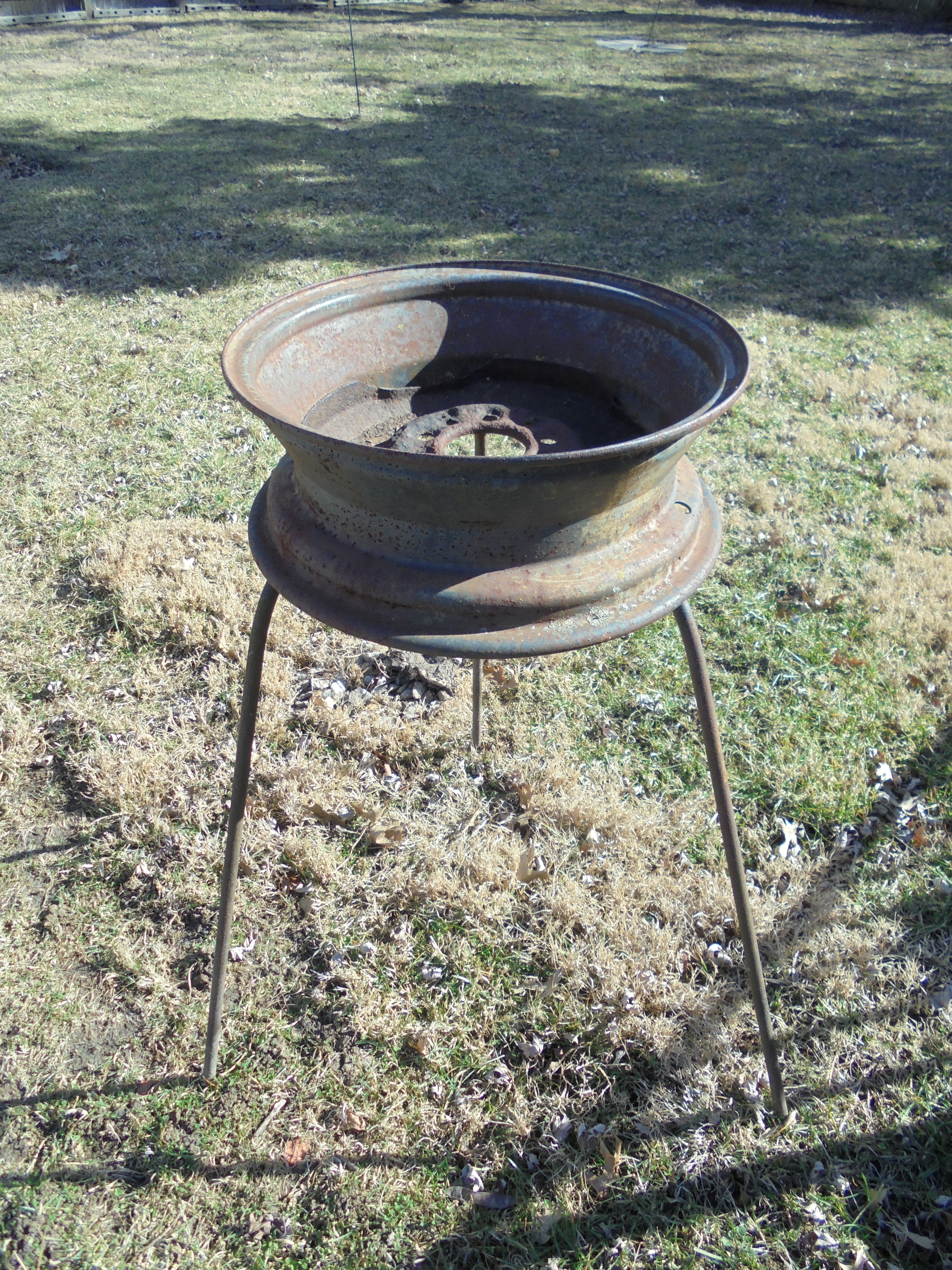 lot 420 image: OLD WHEEL TURNED INTO A PLANT STAND