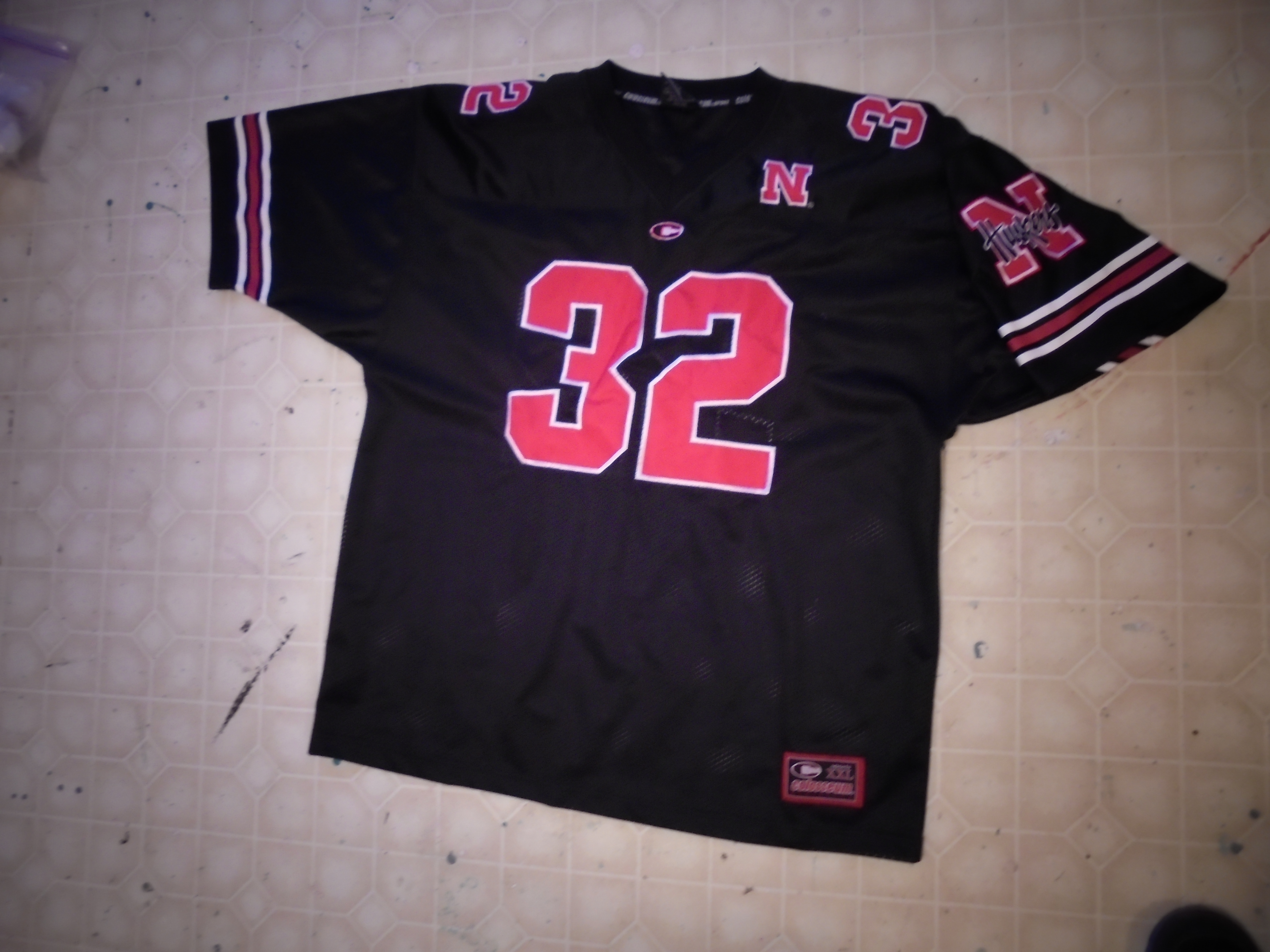 lot 837 image: NEBRASKA CORNHUSKERS BLACK & RED JERSEY
