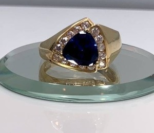 lot 93 image: 14k Yellow Gold, 1.3ct Trillion cut Sapphire and Crystal Ring