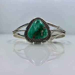 lot 31 image: Sterling Silver and Broken Arrow Turquoise Bracelet by Dave Skeets