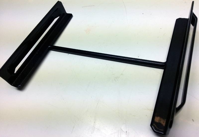 lot 1444 image: Made to hold in place a vehicle battery is this rubberized bracket that fits a 6-78 wide battery.