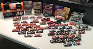 lot 1094 image: Over Sixty Tony Stewart Action 164 Scale Race Cars with Bonus Lunchbox with some New in Package