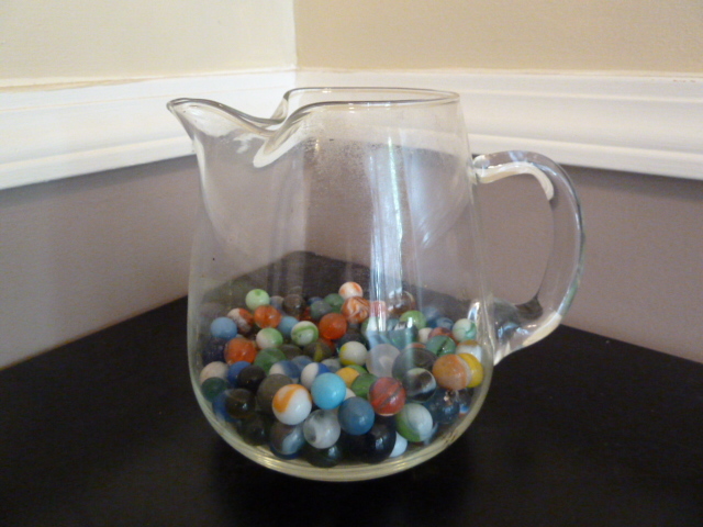 lot 517 image: GLASS PITCHER with bunch of marbles in it