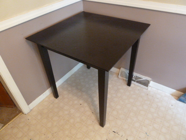 lot 616 image: 30 inch square black table...one corner has a little damage
