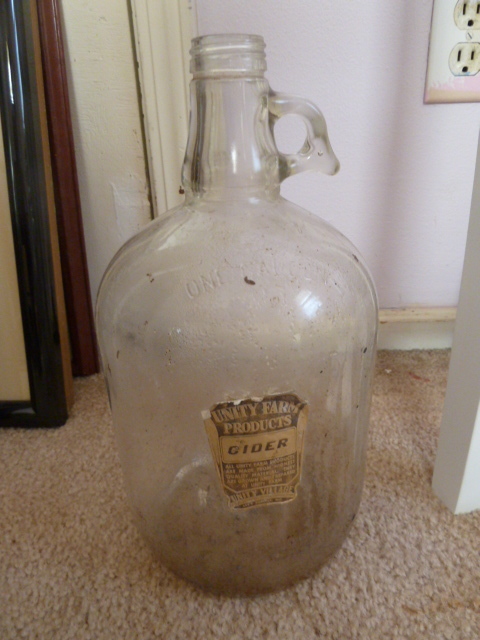 lot 243 image: OLD UNITY FARMS 1 GALLON GLASS  CIDER JUG - UNITY VILLAGE