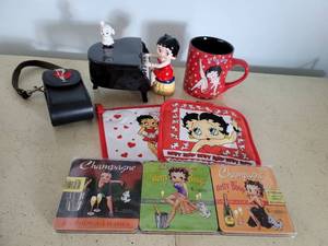 lot 2192 image: Lot of Betty Boop Collectibles (Hot Pads, Coasters, Musical Piano, Phone Case and Coffee Mug)