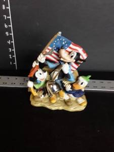 lot 1069 image: Vintage Schmid-Bros. Donald Duck, Goofy, and Mickey Mouse with American Flag Figurine