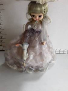 lot 2003 image: Southern Belle Doll. With purple and pink lace dress
