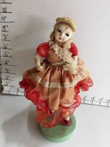 lot 2006 image: Very Old Doll with red dress that needs sewing