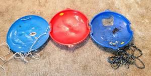 lot 8381 image: (3) Saucer Sleds - 2 are plastic  1 Vintage Flexible Flyer Metal Saucer Sled