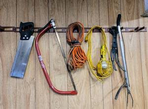 lot 8390 image: Garage Items - Stanley Saw, Bow Saw, Extension Cord, Shop Light and Rubbish Picker