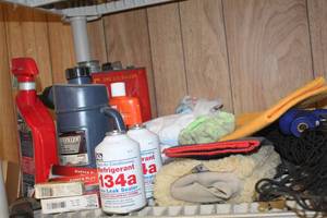 lot 8421 image: Variety Garage Finds- (2) Automotive Refrigerant Cans, Vintage Gasoline Can, BuffersDusters, Scraper Brush Wands, Battery Filler, Lubricant, Spark Plugs, Car Vac and more