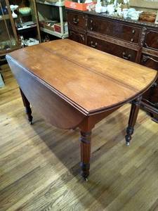 lot 2098 image: Vintage round drop leaf dining table on casters