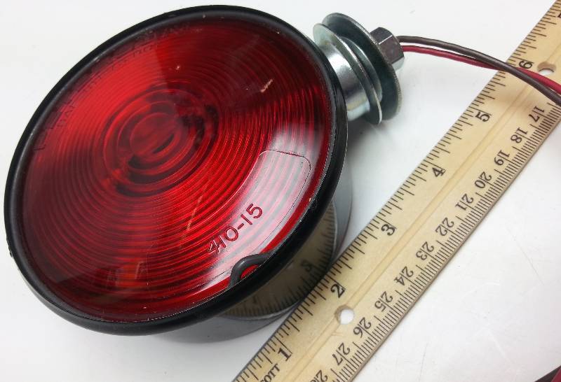 lot 1510-2 image: Single School bus or truck fender or top mounted Brake and turn signal Red light assembly.