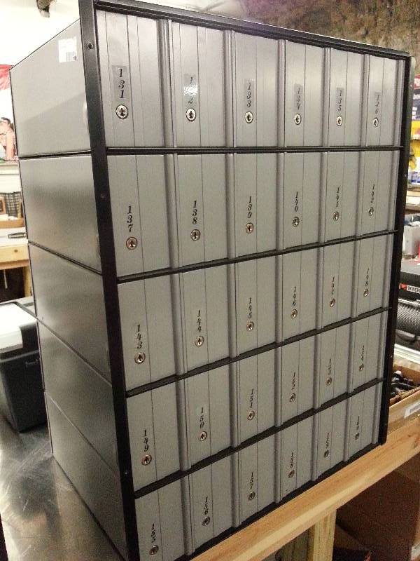 lot 1513-2 image: From a Mail Boxes and More that has closed store is this mail box lock set of 30 boxes #131 thru #160 made to be built in the wall.  Most keys are included, a few have been lost.