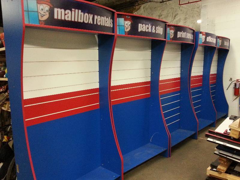 lot 1544 image: Store closing Going Postal display system including 5 of these 8 foot tall slat wall displays with back lighting.