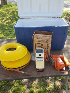lot 3089 image: Drill bit sharpener, jigsaw and cord keepers in Coleman ice chest - Coleman chest splitting on end
