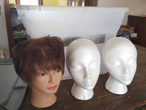 lot 3124 image: wig stands and plastic tub