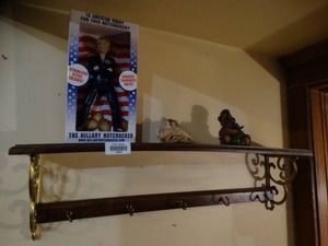 lot 19993 image: Small Shelf With Hilary Clinton Nut Cracker