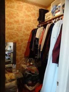 lot 35219 image: Contents of Closet-- Large Amount of Womens Clothing, Blue Floral Ottoman, Hangers, Etc