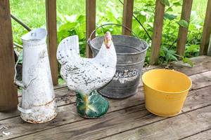 lot 5312 image: Outdoor Ensamble, 19 Concrete Hen, Aluminum Nesco Bucket, Watering Tin with Wooden Handle and Yellow Metal Planting Tin