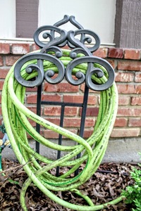 lot 5321 image: Aluminum Cast Metal Hose Holder Decorative Garden Hose Stand and Hose