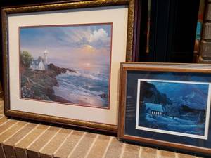 lot 1130 image: Curtis Framed Art Pair Oceanside Beacon 25 x 30 in and Winter Cottage 14 x 17 in