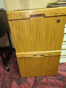lot 2046 image: Two drawer letter size wood file cabinet on wheels, no key. 27x21x16 inches