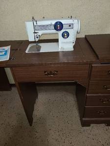 lot 2208 image: Sewing machine in cabinet, though top in need of repair