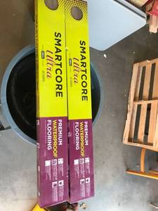 lot 1106 image: Smart core ultra premium waterproof flooring. Norfork pine. Retail $53 a box two boxes.