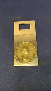 lot 1530 image: St Joe hospitals bottle opener with large Italian coin made in Italy