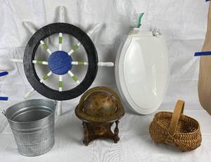 lot 9891 image: Nautical Decor Lot - Fishing pail, Globe for Navigating, Decorative Ship Wheel, Basket for Fish and an elongated commode seat in excellent condition with hardware