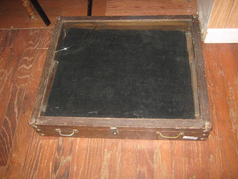 lot 7004 image: Large handmade wooden display cabinet, angled top, hinged cracked glass, carrying handles