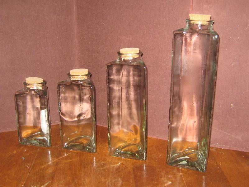 lot 7206 image: Triangle Cannister set of 4 with corks