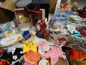 lot 37140 image: Collection of Older Dolls - with a lot of vintage play dishes - amazing doll clothes for different dolls - a mini sofa - all in a case