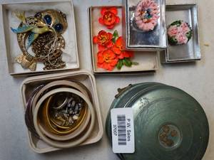 lot 37007 image: Vintage blue metal box, owl necklace with big blue eyes, day-glow orange flower pinearring set, beaded earrings, bracelets and several vintage pins for clothing or hats