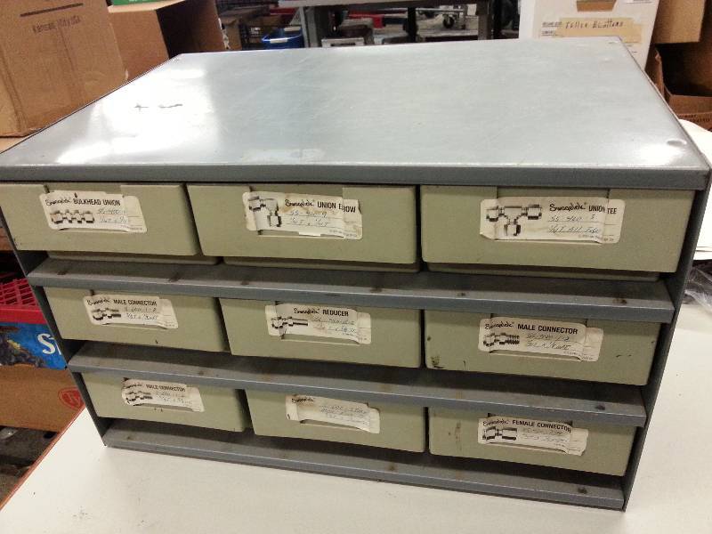 lot 1785 image: About 40 pounds of stainless steel air and hydraulic fittings in metal cabinet.  Most are new with a few used.