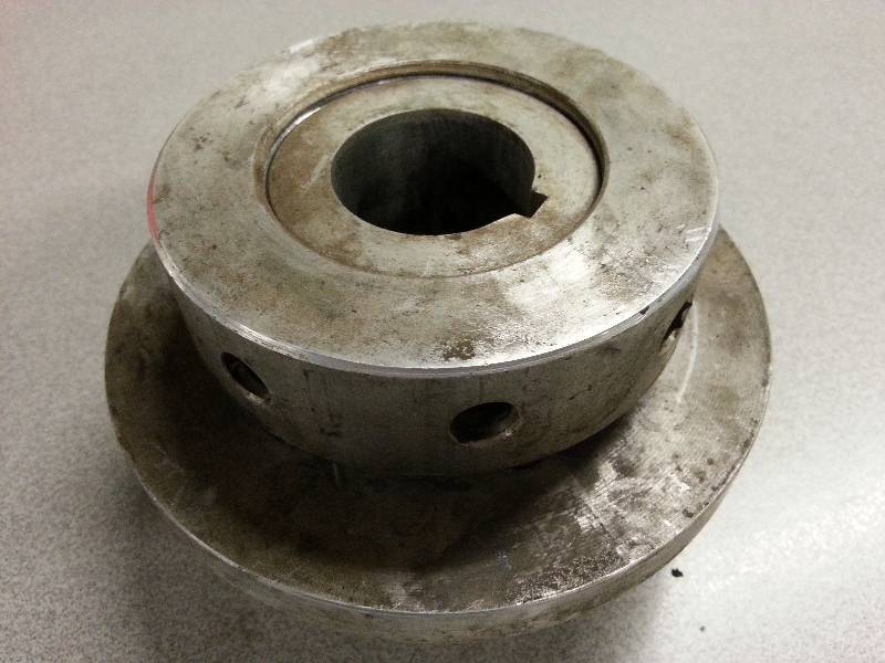 lot 1819 image: Serious motor to pulley flange.  5 inches OD and made for 1-38 inch shaft.  Wash it and use it.