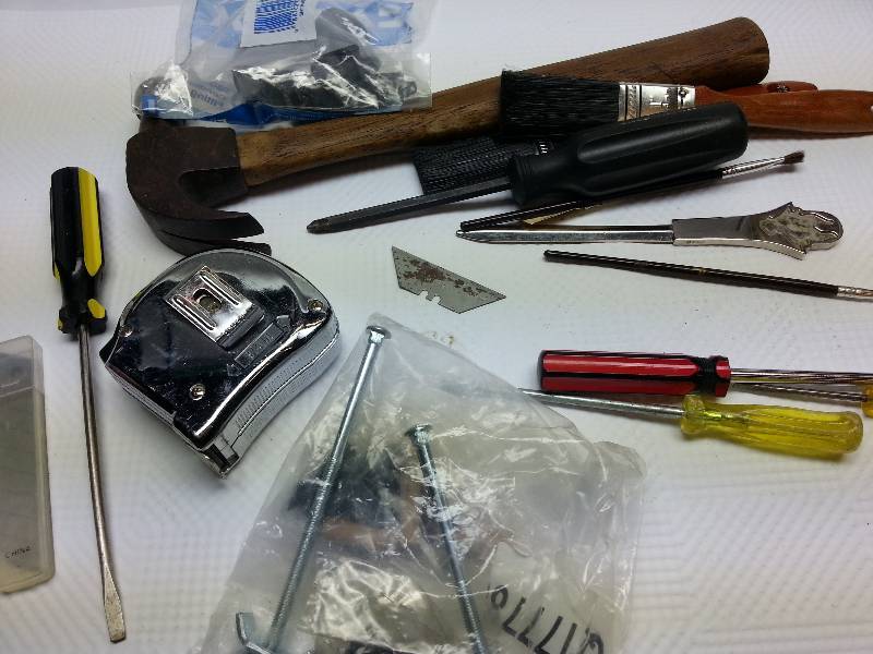 lot 1838 image: Another box of tools including the old fashion Claw Hammer, new knife blades and tape measure