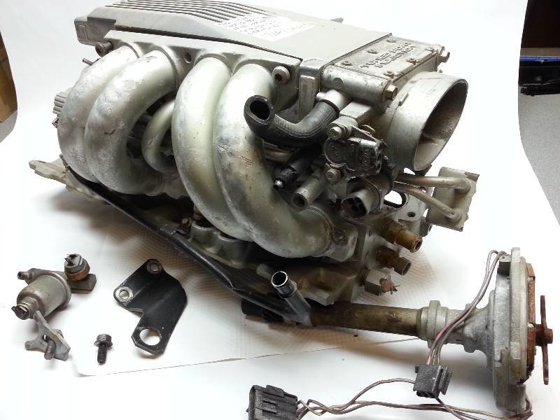 lot 1840 image: For parts or individual pieces is this early 86 an older Tuned Port SB Chevy package shown in the photos.