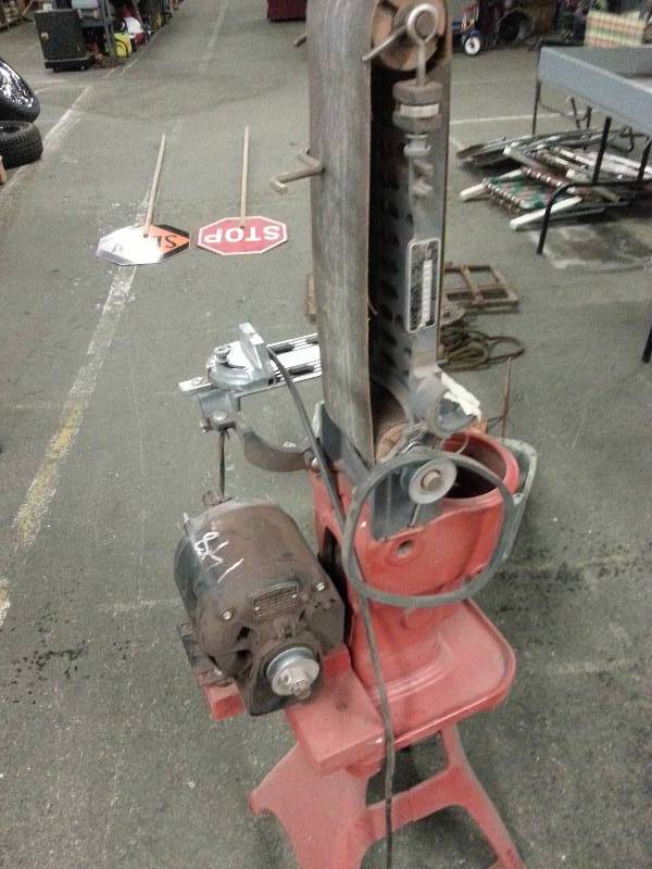 lot 3012 image: Shop belt sander with cast iron table base and a bunch of sanding belts included.