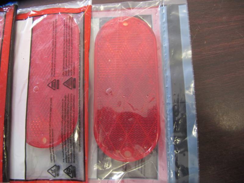 lot 1658 image: 4 NEW Truck-lite Red Oblong reflector with tape #54-3