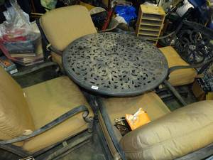 lot 23970 image: Round Metal Patio Table and 4 Matching Chairs with Tan Cushions