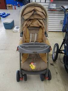 lot 24519 image: Evenflo Animal PrintTan Stroller