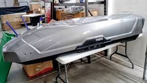 lot 8143 image: Thule Motion XT Cargo Box in Titan, XXL Weight 56 lbs. Load capacity 165 lbs. Cargo Dimensions 91 L x 36 H x 19 - Max Ski Length  85