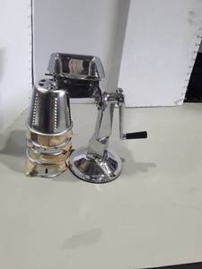 lot 1090 image: Stainless Steel Meat Grinder with 5 Different Blades. Appears to be new and or slightly used