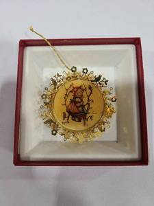 lot 1412 image: The Hummel Gold Christmas Ornament Collection Apple Tree Girl