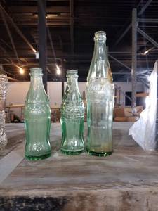 lot 852 image: three Glass coca cola bottles