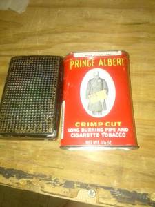 lot 939 image: Cigarette holder and prince Albert crimp cut can