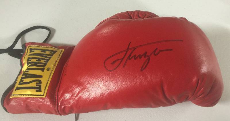 lot 1151 image: Smoking Joe Frazier Signed Boxing Glove with Certificate of Authenticity